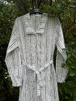 Eco-friendly linen shirt dress, featuring a relaxed fit, button-down front, and breathable fabric perfect for warm weather.