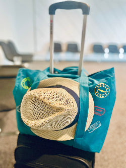 A versatile, eco-friendly travel tote bag made from 100% canvas cotton fabric, featuring hat straps, multiple pockets for organization, and customizable visa stamp stickers. Available in 15 vibrant colors, it's the perfect companion for globetrotters, offering durability and style for any adventure.